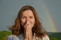 Woman standing in front of a rainbow, good fortune